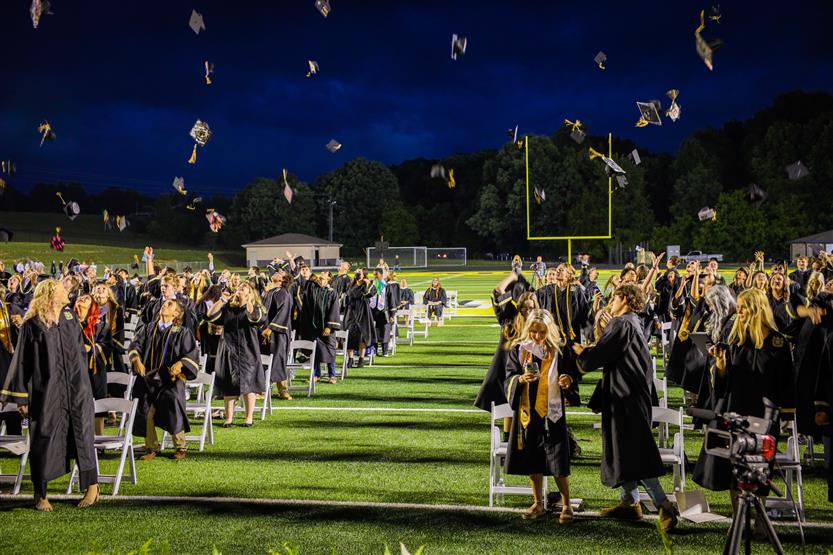 Students graduate on a football field